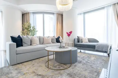 a living room with a couch and a table at Vogue Downtown Opera Grand near Burj Khalifa and Dubai Mall, Two Bedroom Apartment with Large Balcony and Access to all Amenities in Dubai