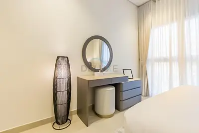 a bedroom with a sink and a mirror at Balcony-Facing Pool 2BR with Assistant Room, Minutes Walk to Park, Miracle and Butterfly Garden, Divine Living, Arjan by Deluxe Holiday Homes in Dubai