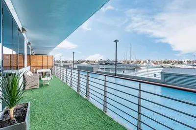 a balcony with a view of a body of water at Palm Home next to Nakheel Mall with Private Beach in Dubai