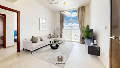 a living room with a couch and a tv at Family-Friendly 2BR in Azizi Plaza with Pool & Gym in Dubai