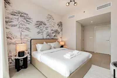 a bedroom with a large bed with white sheets at Luxury 2BR Downtown Steps from Burj Khalifa in Dubai