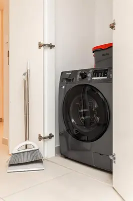 a washer and dryer in a room at Luxury 2BR Downtown Steps from Burj Khalifa in Dubai