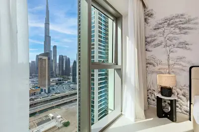 a room with a window with a view of a city at Luxury 2BR Downtown Steps from Burj Khalifa in Dubai