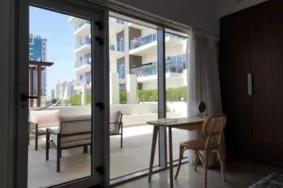 a room with a balcony with a table and chairs at Modern Stay in Azizi Samia1BR Al Furjan in Dubai