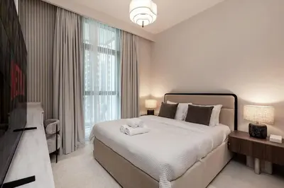 a bedroom with a large bed and a television at Luxury 2BR Burj Crown Stay Downtown in Dubai