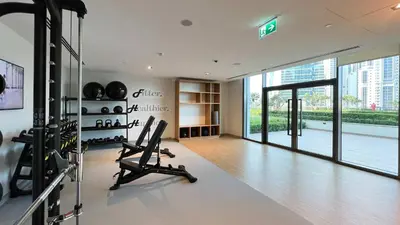 a gym with treadmills and ellipticals in a building at Luxury 2BR Burj Crown Stay Downtown in Dubai