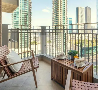 a balcony with a table and chairs on a balcony at Modern 1BR theme and Burj Khalifa View Downtown in Dubai