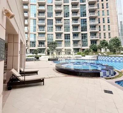 a large building with a fountain in front of a building at Modern 1BR theme and Burj Khalifa View Downtown in Dubai