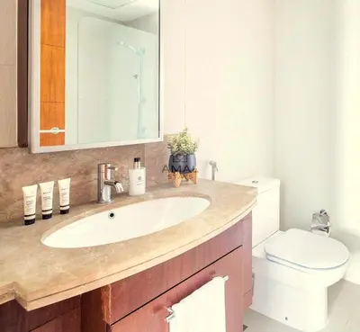 a bathroom with a sink and a toilet at Modern 1BR theme and Burj Khalifa View Downtown in Dubai