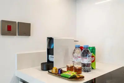 a counter with bottles of water and a coffee maker at BLVD-Beachfront Luxe Stay with Private Beach Access in Dubai