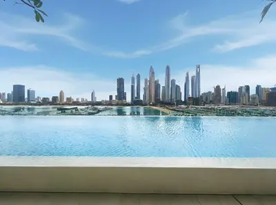 a view of a city skyline from a swimming pool at BLVD-Beachfront Luxe Stay with Private Beach Access in Dubai