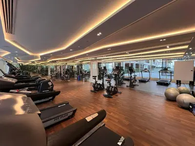 a gym with a lot of treadmills and exercise equipment at Luxurious Haven Studio In Jewelz Arjan 03 in Dubai