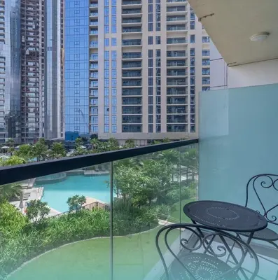 a balcony with a table and a view of a city at Luxury Studio With Pool View Near Burj Khalifa in Dubai