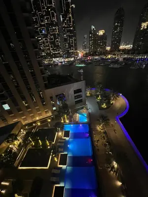 a view of a building at night with a city at Modern 2-Bedrooms Apartment with Stunning Marina Views in Dubai