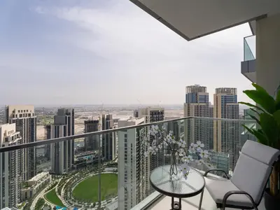 a balcony with a table and chairs and a city at The Grand Majestic Sky Luxe 1BR Sleeps 4 06 in Dubai