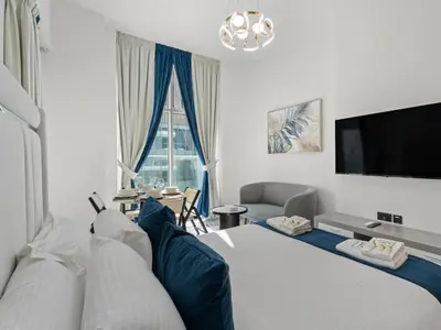 a hotel room with a bed and a tv at Opalz Reverie Luxe Studio Escape 08 in Dubai