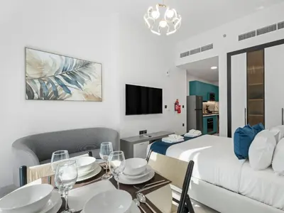 a room with a bed and a dining table and a bed at Opalz Reverie Luxe Studio Escape 08 in Dubai