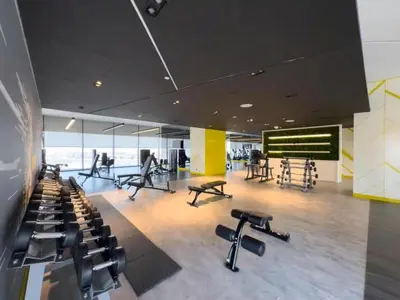 a gym with treadmills and exercise equipment in a building at Modern Luxury Stylish 2BR Near Downtown Aykon C in Dubai