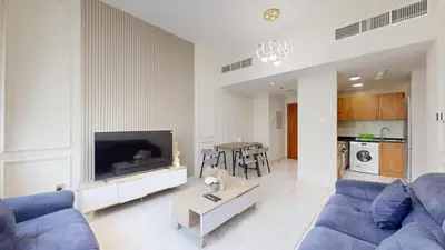 a living room with a blue couch and a tv at Marina View Tower 2BR Stunning Canal Views in Dubai