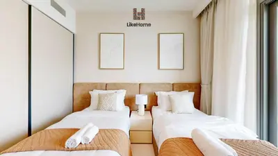 two twin beds in a room with two mirrors at Chic 2BR Getaway Marina Vista T2 Sea view in Dubai