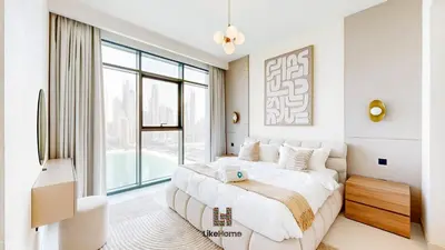 a bedroom with a large bed and a large window at Chic 2BR Getaway Marina Vista T2 Sea view in Dubai