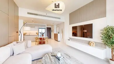 a living room with a white couch and a tv at Chic 2BR Getaway Marina Vista T2 Sea view in Dubai