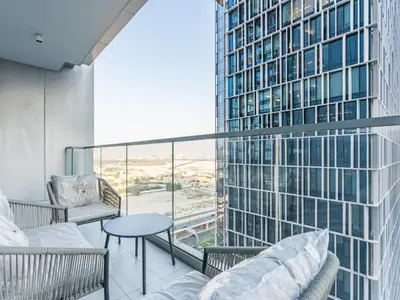 a balcony with a couch and a table and a building at Vida Residences 2BR-Direct Dubai Mall Access in Dubai