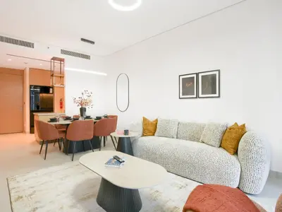 a living room with a couch and a table at Vida Residences 2BR-Direct Dubai Mall Access in Dubai