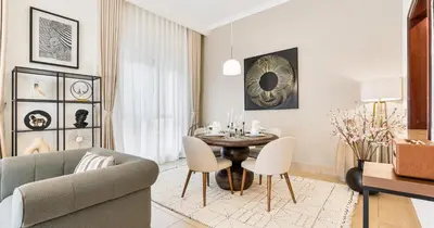 a living room with a table and a couch at Downtown 2BHK Burj View & Private Garden in Dubai