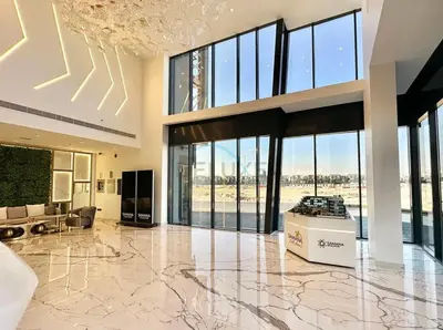 a large lobby with a large floor to ceiling windows at Inviting Studio Overlooking the Pool, Just a Short Drive from Dubai Autodrome, Samana Golf Avenue, Dubai Studio City by Deluxe Holiday Homes in Dubai