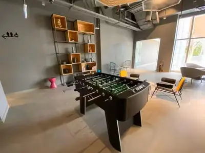 a living room with a large chess board in the middle at Vogue JVT Novotel near Springs Souk Mall, One Bedroom apartment with Balcony and Vibrant Community View, Access to all Amenities in Dubai