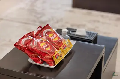 a pile of chips in a bowl on a table at Luxury Studio Retreat! Heart of Downtown Dubai! in Sabkhah