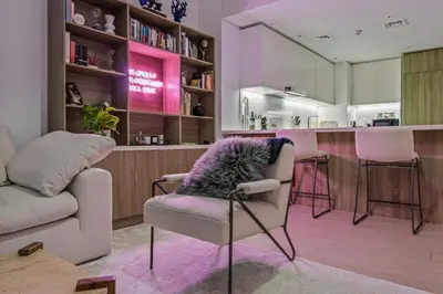 a living room with a couch and a chair at Trendy Marina 2-Bedroom Apartment in Dubai