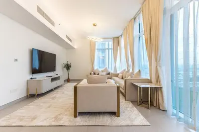 a living room with a couch and a tv at Cozy 2BR Near Zabeel Park - Dubai frame view in Dubai