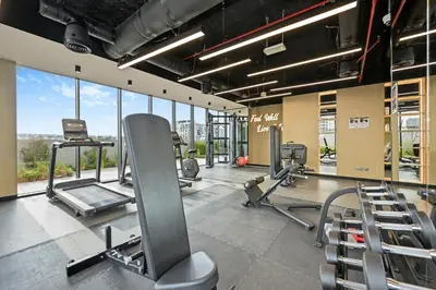 a gym with treadmills and cardio equipment in a building at New Stylish Apartment, Metro 5min walk, Dubai Marina 20min in Dubai