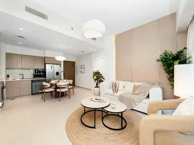 a living room with a couch and a table at 2BDR - Burj Khalifa view with Private terrace in Dubai