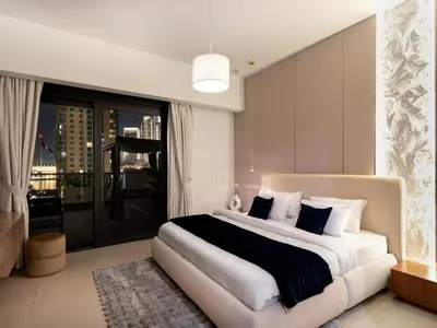 a bedroom with a large bed and a large window at 2BDR - Burj Khalifa view with Private terrace in Dubai