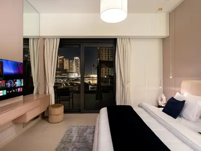 a bedroom with a bed and a large window at 2BDR - Burj Khalifa view with Private terrace in Dubai