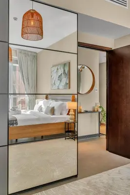 a bedroom with a bed and a large glass door at The Torch Cozy 1BR Marina Near JBR & Metro in Dubai