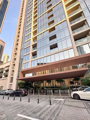 a large building with cars parked in front of it at PVH - Contemporary 1BR Near Burj Khalifa - Forte Tower 2 in Dubai