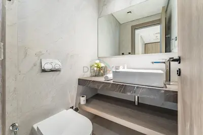 a bathroom with a sink and a mirror at Community View 1BR, Just 15minutes to Miracle Garden - Oxford Boulevard, Jumeirah Village Circle by Deluxe Holiday Homes in Dubai