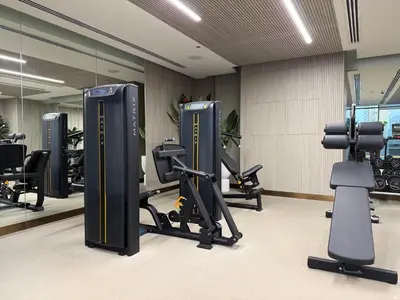 a gym with tread machines and mirrors in a room at Pearl House 2 in Dubai