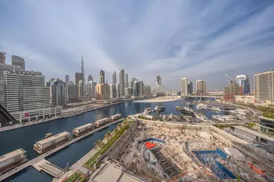a view of a city with a river and buildings at StayShort - 1 Bedroom Sleeps 2 with City Views in Business Bay in Dubai