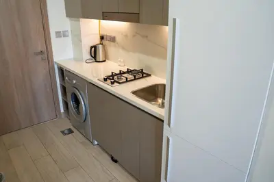 a kitchen with a sink and a stove at Burj Khalifa View Studio 10 mins away Dubai Mall in Dubai