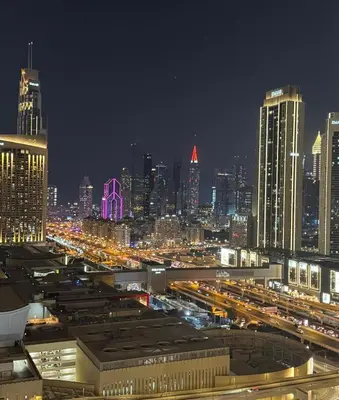a night view of a city with traffic at High floor downtown apartment opposite Dubai Mall in Dubai