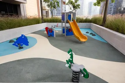 a small playground with a slide and a slideintend at Cozy studio with Burj Khalifa and canal view in Dubai