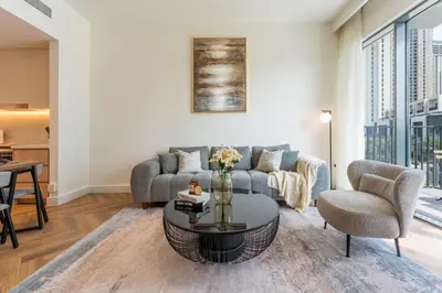 a living room with a couch and a table at ShoresInn - Luxury Dubai Creek Harbour Stay in Dubai