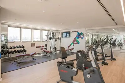a gym with treadmills and exercise equipment in a building at Spacious 1BR in Creek Harbour with Gym and Pool in Dubai