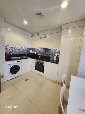 a kitchen with white cabinets and a dishwasher at Majestic Canal View 2Bhk 6pax in Dubai