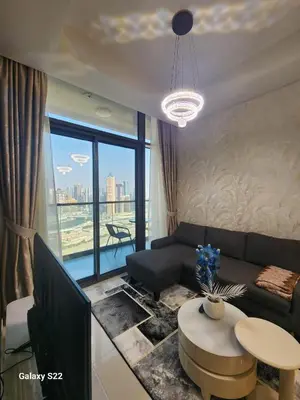 a living room with a couch and a table at Majestic Canal View 2Bhk 6pax in Dubai